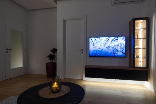 a living room with a tv on a wall at City Luxury in Trebinje