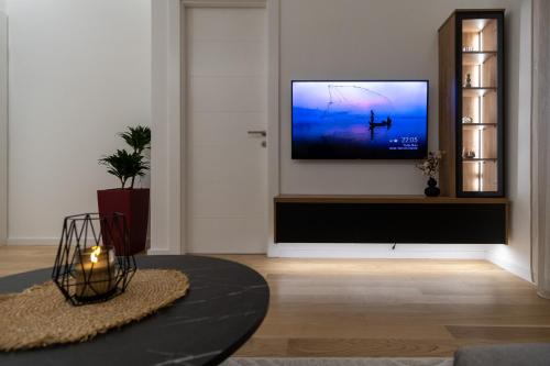 a living room with a flat screen tv on a wall at City Luxury in Trebinje