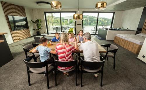 a group of people sitting around a table at Hotel Kras in Jedovnice