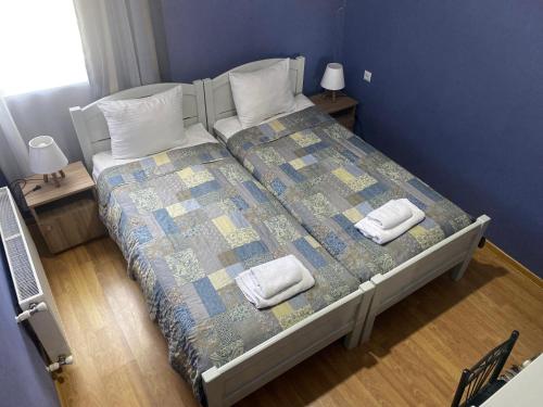 a bedroom with a bed with two towels on it at Hillside Guesthouse in Borjomi