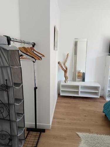 a living room with a mirror and a dresser at Chez Éric in Fréjus