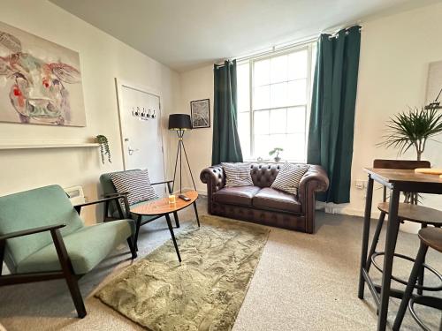 a living room with a couch and a table at Land Of Green Ginger Apartment- City Centre in Hull