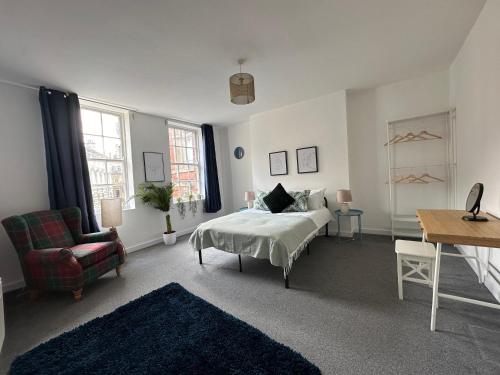 a bedroom with a bed and a chair and a desk at Land Of Green Ginger Apartment- City Centre in Hull