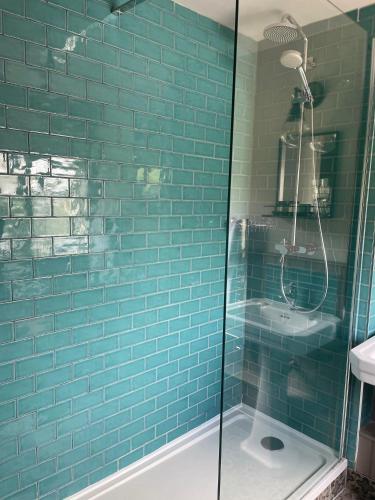 a bathroom with a shower and a sink at Dartmoor Halfway Inn in Newton Abbot