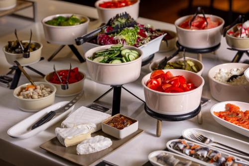 a buffet of food on a table with appetizers at Movenpick Hotel Tallinn in Tallinn