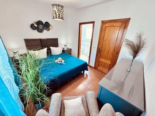 een woonkamer met een blauw bed en een bank bij Casa Elena in Sant Pere Pescador