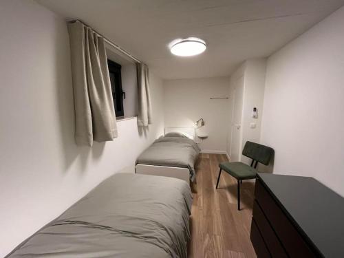 Un pat sau paturi într-o cameră la Vakantiewoning Renard Ronse