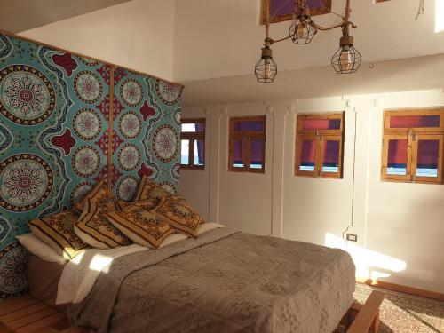 a bedroom with a bed with a colorful wall at Das! Boot auf dem Meer in Safaga 