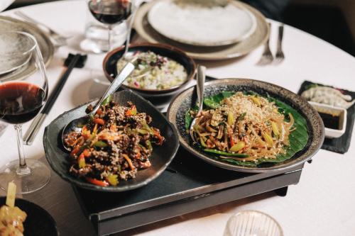 three bowls of food on a table with wine glasses at Corinthia Palace Malta in Attard