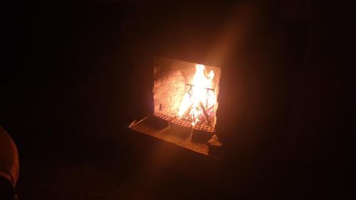 a fire in a brick fireplace in the dark at Das! Boot auf dem Meer in Safaga 