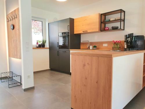a kitchen with wooden cabinets and a counter top at Ferienhaus Berger mit eigenen Whirlpool im Garten in Garmisch-Partenkirchen