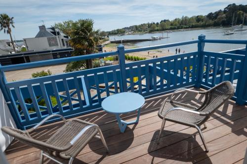 a table and chairs on a deck with a view of the beach at Best Western Plus Le Roof Vannes Bord de Mer in Vannes