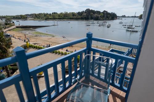 a balcony with a view of a beach and boats at Best Western Plus Le Roof Vannes Bord de Mer in Vannes