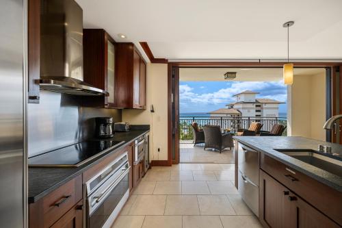 a kitchen with a view of the ocean at Ko Olina Beach Villas O1004 in Kapolei