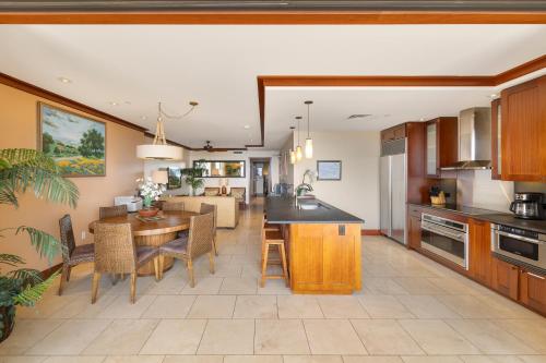 a kitchen and living room with a table and chairs at Ko Olina Beach Villas O1004 in Kapolei