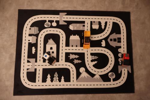 a board with a toy train on a road at Stuga Fyra Säsonger - Fishing - Skiing - Hottub in Filipstad