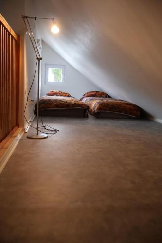 a room with two beds in the corner of a room at Stuga Fyra Säsonger - Fishing - Skiing - Hottub in Filipstad