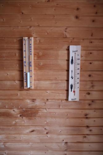 three books sitting on top of a wooden wall at Stuga Fyra Säsonger - Fishing - Skiing - Hottub in Filipstad