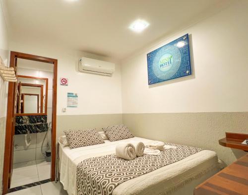a bedroom with a bed with shoes on it at Mini Hotel in Jericoacoara