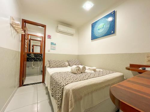 a bedroom with a bed and a bathroom with a shower at Mini Hotel in Jericoacoara