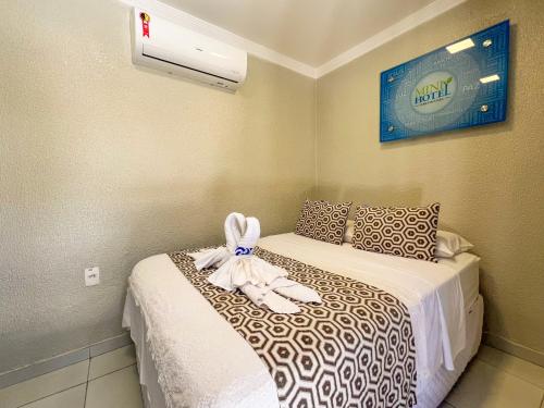a bedroom with two beds and a air conditioner at Mini Hotel in Jericoacoara