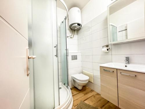 a bathroom with a toilet and a sink at Apartments Habek 2 in Vrboska