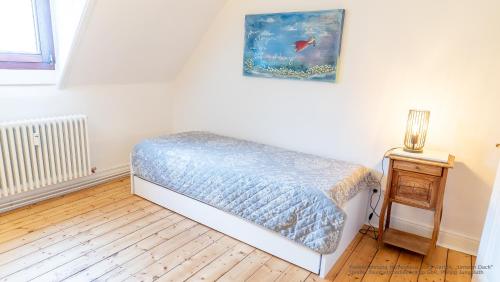a bedroom with a bed and a lamp on a table at Herrenhaus Burg Vlatten in Heimbach