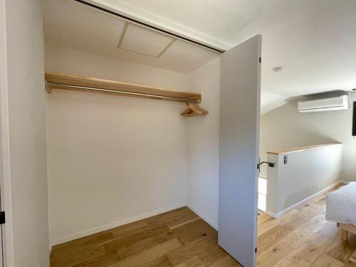 an empty room with a closet and a door at Spruce Cottage in Yuzawa