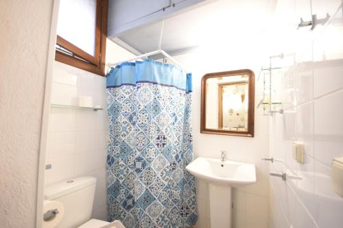 a bathroom with a sink and a toilet and a mirror at Masì House in Rhodes Town