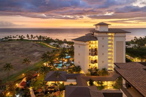 an aerial view of a hotel and the ocean at sunset at Ko Olina Beach Villas O1402 in Kapolei