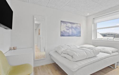 a white bedroom with a bed and a window at Gorgeous Home In Skagen With Wifi in Skagen