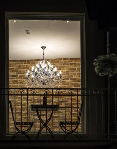 a chandelier hanging over a table on a balcony at Casa Andrea in La Morra