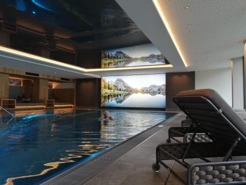 una piscina in un hotel con una persona in acqua di Ferienhof zur Sonne a Tux