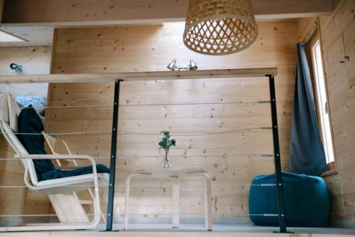 a room with a wooden wall with a chair and a lamp at Charming Tiny House in LʼIsle-sur-la-Sorgue