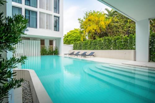 a swimming pool in the middle of a building at Saan Hotel Sathorn in Bangkok