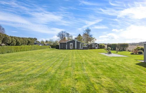 un gran patio con una casa al fondo en Gorgeous Home In Svendborg With Wifi, en Svendborg