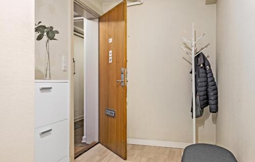 a hallway with a wooden door and a chair at Amazing Apartment In Kolding With Wifi in Kolding