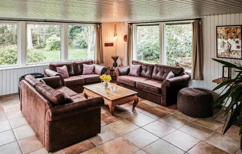 a living room with couches and a coffee table at Four-Bedroom Holiday Home In Vaggerlose in Marielyst