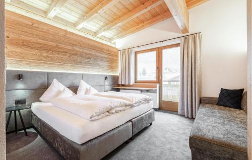 a bedroom with a large bed and a window at 2 Bedroom Awesome Apartment In St, Anton in Sankt Anton am Arlberg