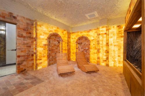two chairs in a room with a brick wall at Juvena Hotel Wellness & SPA Adults Only 12 plus in Międzywodzie