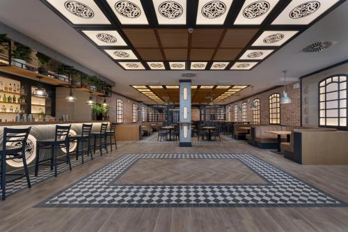 a restaurant with tables and chairs and a ceiling at Juvena Hotel Wellness & SPA Adults Only 12 plus in Międzywodzie