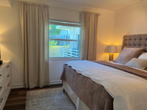 a bedroom with a large bed and a window at Holiday Isle Yacht Club in Fort Lauderdale