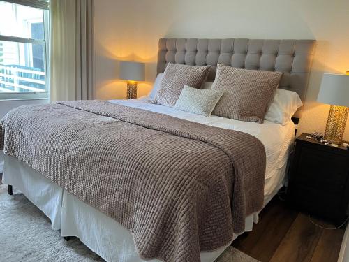 a large bed in a bedroom with two lamps at Holiday Isle Yacht Club in Fort Lauderdale