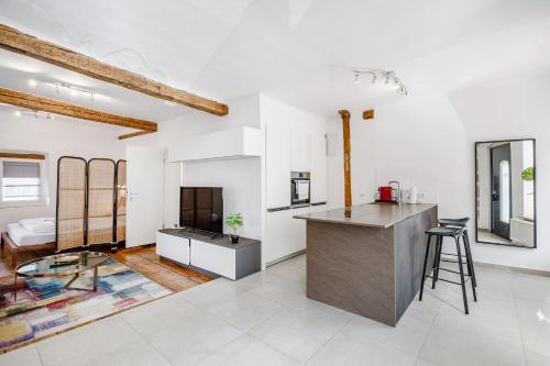 een keuken en een woonkamer met witte muren en houten balken bij Am Weissen Turm in Kulmbach