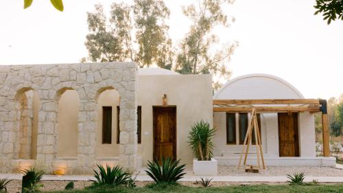 a small white house with a church at Tzila Lodge in Fayoum Center