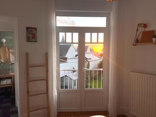 a door leading to a balcony with a view at KYPRYS - Villa 1930 - Wimereux in Wimereux