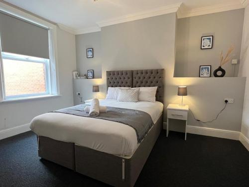 Un dormitorio con una cama grande y una ventana en Alexander Hotel, en Whitley Bay