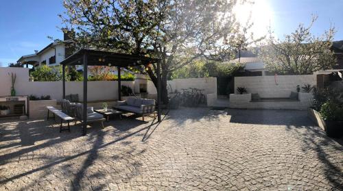 a patio with a table and chairs under a canopy at Casa da Avó Olinda in Góis