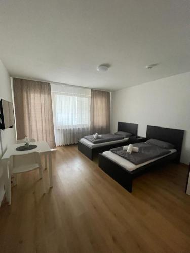 a large room with two beds and a table at Renoviert, modern und ruhig in Nuremberg