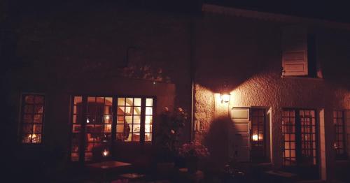 a dark room with windows and a building at Les Vagabonds du Mont in Chichilianne